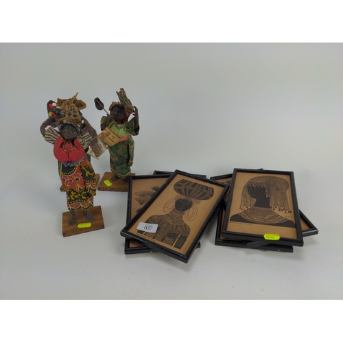 107 - Three dolls of Zimbabwe in traditional costume, ht. 26cm, together with six framed African prints
