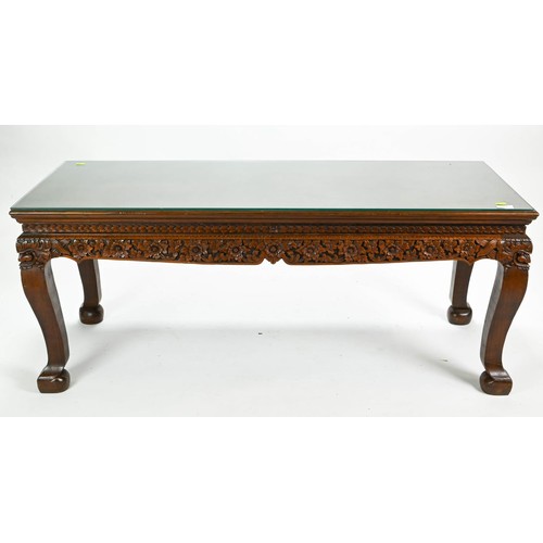 54 - Eastern hardwood ornately carved coffee table with glass top w126 x d51 x h51cm