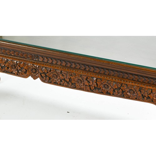 54 - Eastern hardwood ornately carved coffee table with glass top w126 x d51 x h51cm