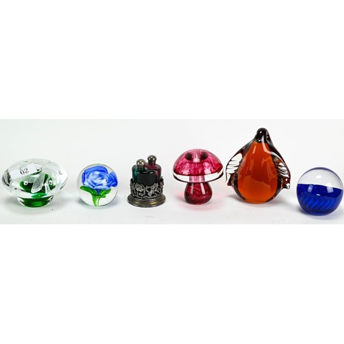 62 - Five paperweights together with two glass scent bottles on a white metal base