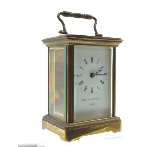 301 - Matthew Norman London brass cased carriage clock, height including handle 14.5cm, with key