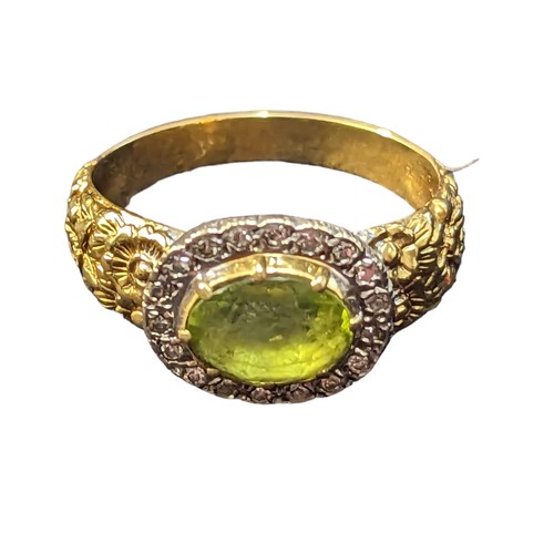 59 - Peridot and diamond cluster ring, stone set in white metal and mounted on 18ct gold with floral reli... 