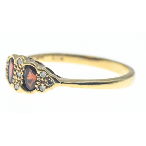 60 - 9ct gold ring set with orangey red paste and diamond accents. Size N 1/2. Gross weight 2.02g