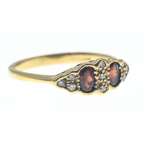 60 - 9ct gold ring set with orangey red paste and diamond accents. Size N 1/2. Gross weight 2.02g