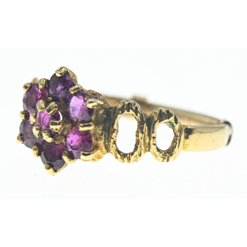 72 - Pink sapphire, flower cluster ring on 9ct gold featuring openwork shoulders. Gross weight 2.27g