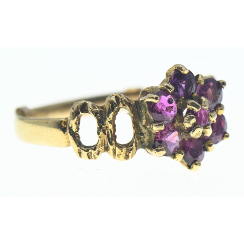 72 - Pink sapphire, flower cluster ring on 9ct gold featuring openwork shoulders. Gross weight 2.27g