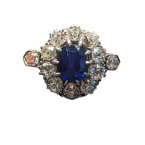 85 - Sapphire and diamond halo cluster ring. The central rectangular cushion cut sapphire is approximatel... 