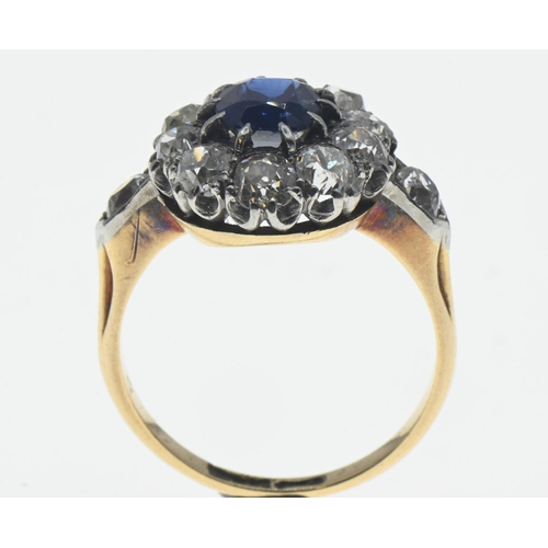 85 - Sapphire and diamond halo cluster ring. The central rectangular cushion cut sapphire is approximatel... 