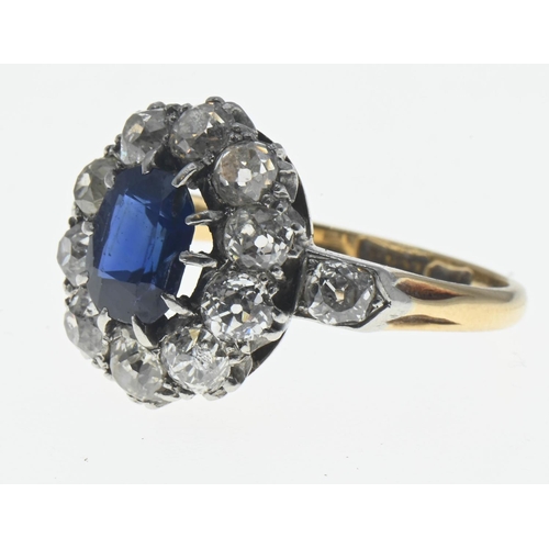 85 - Sapphire and diamond halo cluster ring. The central rectangular cushion cut sapphire is approximatel... 