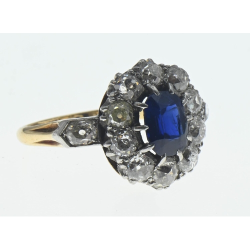 85 - Sapphire and diamond halo cluster ring. The central rectangular cushion cut sapphire is approximatel... 