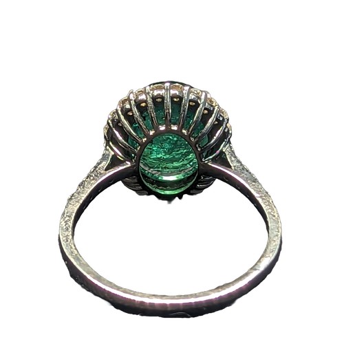 87 - Emerald and diamond halo cluster ring with diamond set shoulders, mounted on 18ct white gold. The cl... 