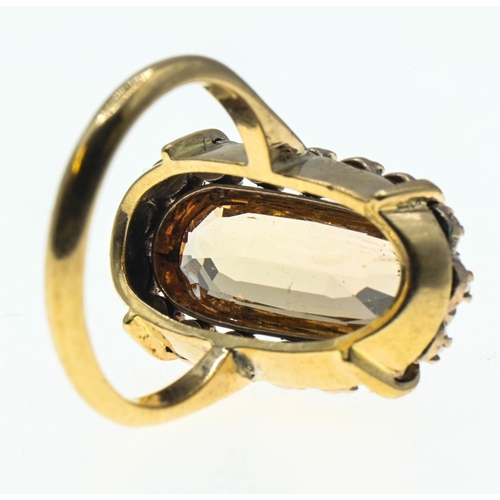 88 - Imperial topaz ring. Central stone (15mm x 6mm) is surrounded by a halo of seed pearls and set in ye... 