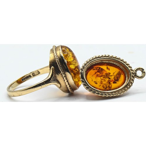 135 - 9ct gold amber set ring and pendant. Ring size L. Gross weight 4.73g