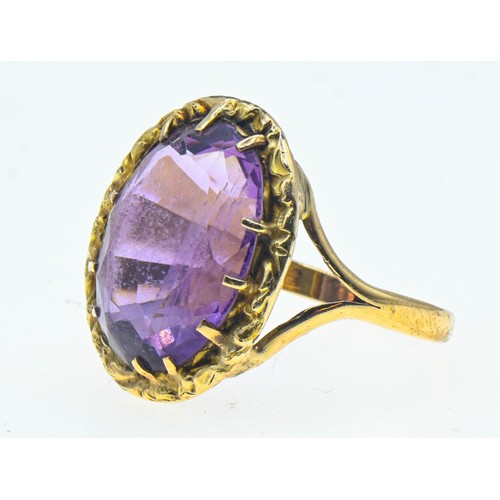 39 - Amethyst set yellow metal ring. Oval mixed cut amethyst approximately 19mm x 14mm. Size T 1/2. Gross... 