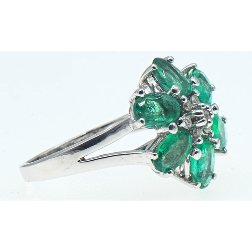 62 - 18ct white gold, emerald and diamond flowerhead cluster ring, size O, gross weight 6 grams