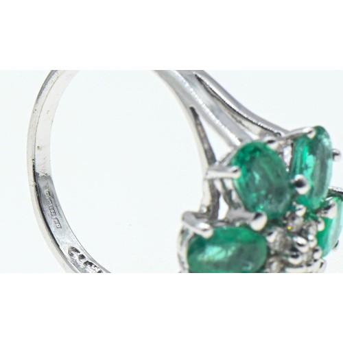 62 - 18ct white gold, emerald and diamond flowerhead cluster ring, size O, gross weight 6 grams