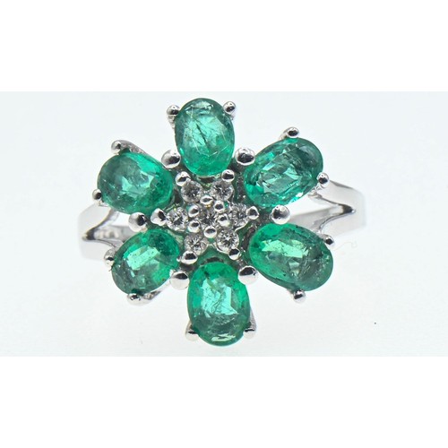 62 - 18ct white gold, emerald and diamond flowerhead cluster ring, size O, gross weight 6 grams