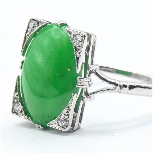 82 - Jade and diamond ring. A Nephrite jade cabochon measuring approx. 14mm x 10mm in a rectangular setti... 