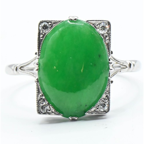 82 - Jade and diamond ring. A Nephrite jade cabochon measuring approx. 14mm x 10mm in a rectangular setti... 