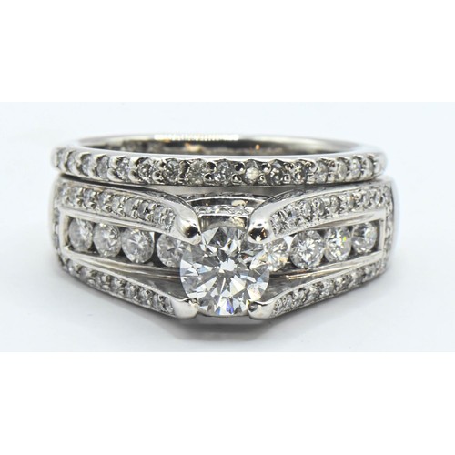 86 - 14ct white gold and diamond ring. Comprising of two rings soldered together. Central round brilliant... 