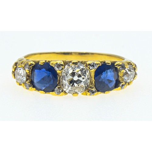 64 - Yellow metal diamond and sapphire ring. The central old cut diamond measures approximately 5.5 x 5mm... 