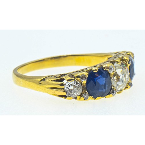 64 - Yellow metal diamond and sapphire ring. The central old cut diamond measures approximately 5.5 x 5mm... 