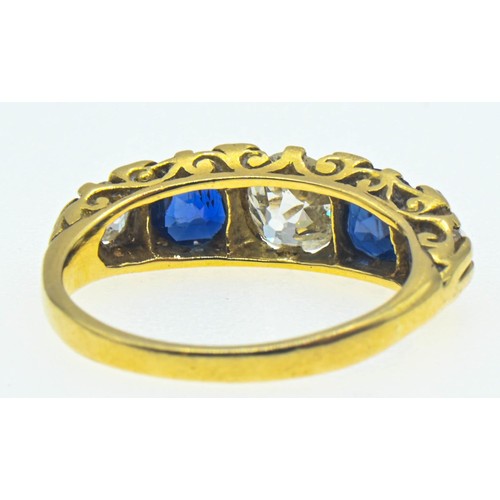 64 - Yellow metal diamond and sapphire ring. The central old cut diamond measures approximately 5.5 x 5mm... 