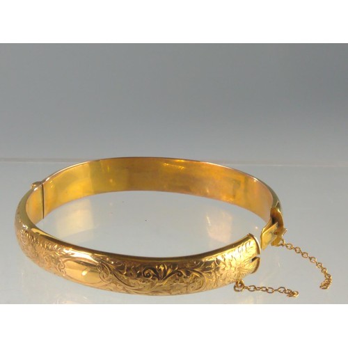 150 - 15ct gold hinged bracelet, engraved with flowers and scrolls to one side, hallmarked Birmingham 1918... 