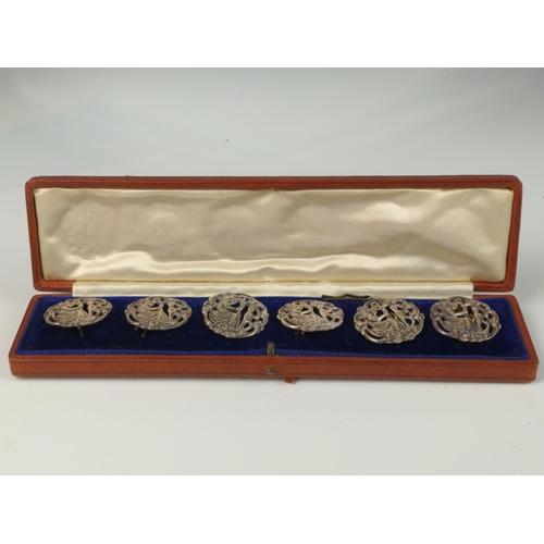 341 - Cased set of six George V silver buttons, William Comyns & Sons, London 1913, of pierced figural... 