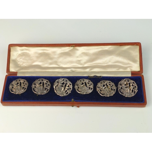 341 - Cased set of six George V silver buttons, William Comyns & Sons, London 1913, of pierced figural... 