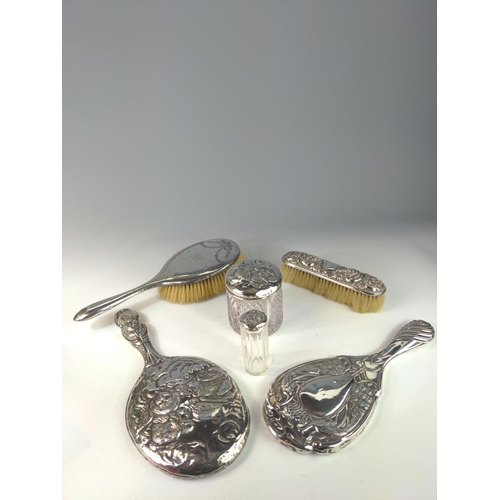 390 - Silver mounted hand mirror and two silver topped glass vanity jars with embossed Reynold's angels, t... 