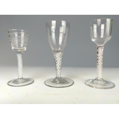 329 - Three English late 18th century double-series opaque twist wine glasses, one with an etched bowl, ea... 