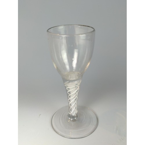 329 - Three English late 18th century double-series opaque twist wine glasses, one with an etched bowl, ea... 