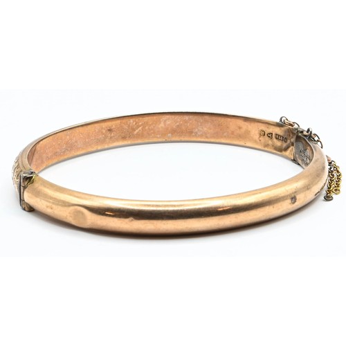 93 - Late Victorian 9ct gold hinged bangle, engraved scroll decoration to the front, hallmarked Chester 1... 