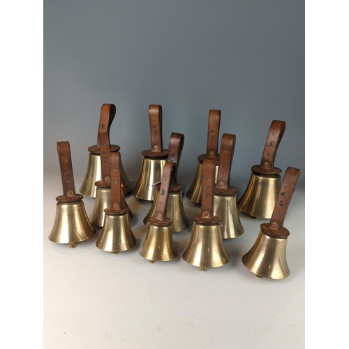 421 - Set of twelve brass leather handled campanology hand bells, leather handles stamped F.R. Barnett and... 