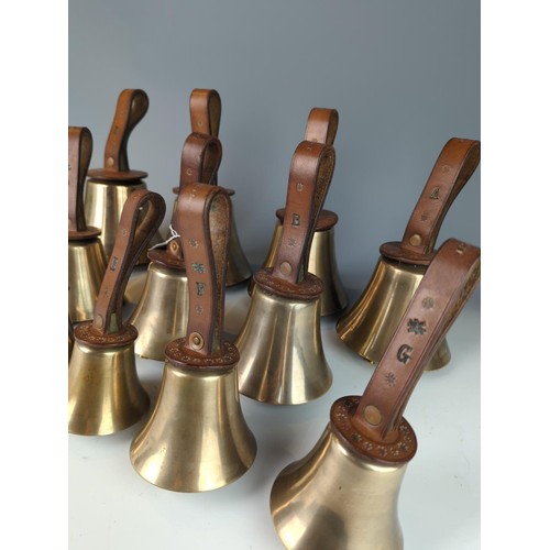 421 - Set of twelve brass leather handled campanology hand bells, leather handles stamped F.R. Barnett and... 