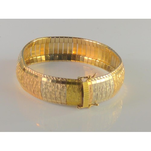 89 - 18ct gold tri- colour omega style bracelet. Gross weight 38.80g.