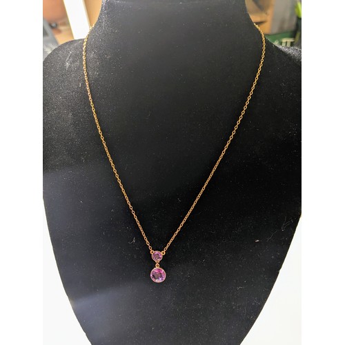 167 - 9ct gold and amethyst pendant on a 9ct gold chain. The two amethysts are modified brilliant cut in a... 