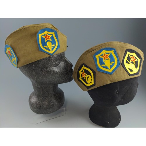 62 - Two military caps with Communist Soviet badges.