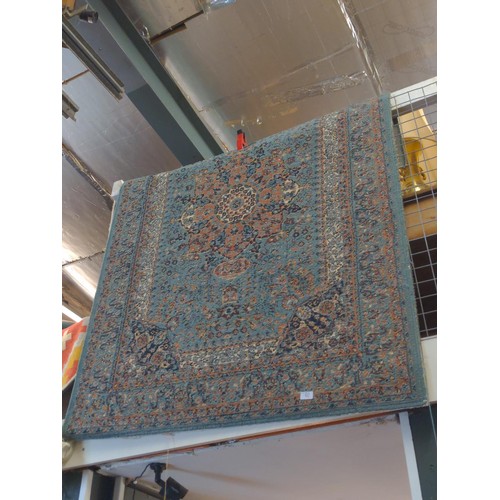 107 - Eastern rug in dusky blue, with central medallion 120cm x 170cm