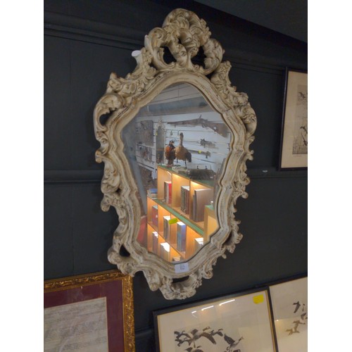 112 - Ornately framed French style shield shaped mirror. Height 71cm x Width 42cm 