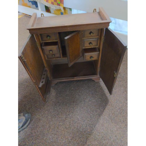 99 - Small wooden smokers cabinet with six internal drawers and central compartment 48 x 24 x 54cm