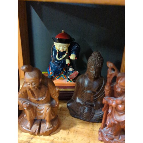 56 - 3 carved Oriental figures inc. Buddha and two others. 