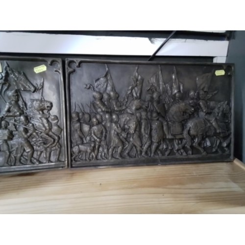 328 - Two bronzed plaster reliefs of battle scenes. 41cm x 25cm