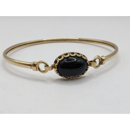 227 - 9ct gold bangle set with cabochon paste stone, gross weight 5.5g