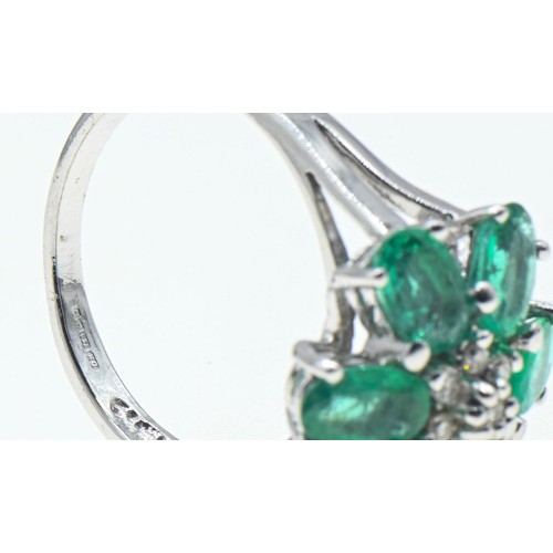 230 - 18ct white gold, emerald and diamond flowerhead cluster ring, size O, gross weight 6 grams