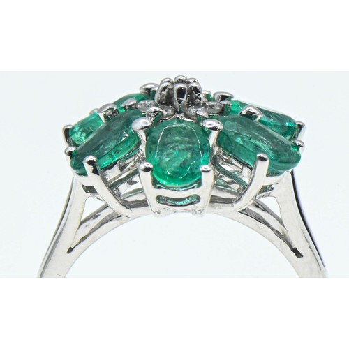 230 - 18ct white gold, emerald and diamond flowerhead cluster ring, size O, gross weight 6 grams
