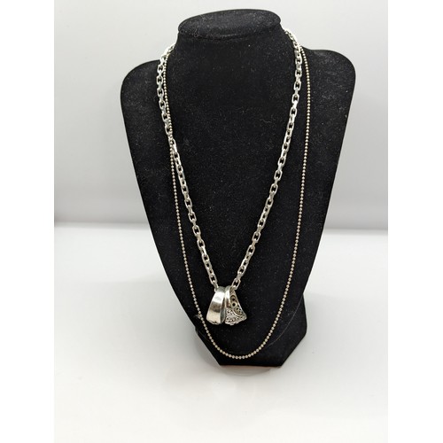 244 - Four pieces of 925 silver jewellery, including two neck chains and two rings (size S & W respect... 