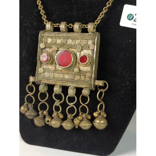 263 - Yemeni or Bedouin white metal necklace with pendant, set with red glass and suspended bells