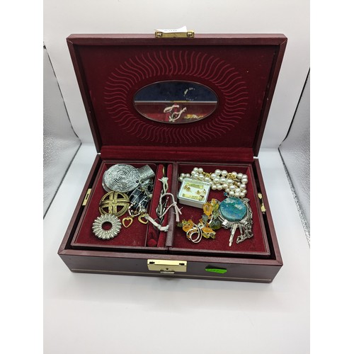 258 - Burgundy coloured jewellery box and contents